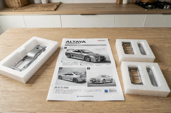 Kit Altaya déballé avec livret d'instructions et pièces détachées de la Nissan Skyline GT-R disposées sur une table